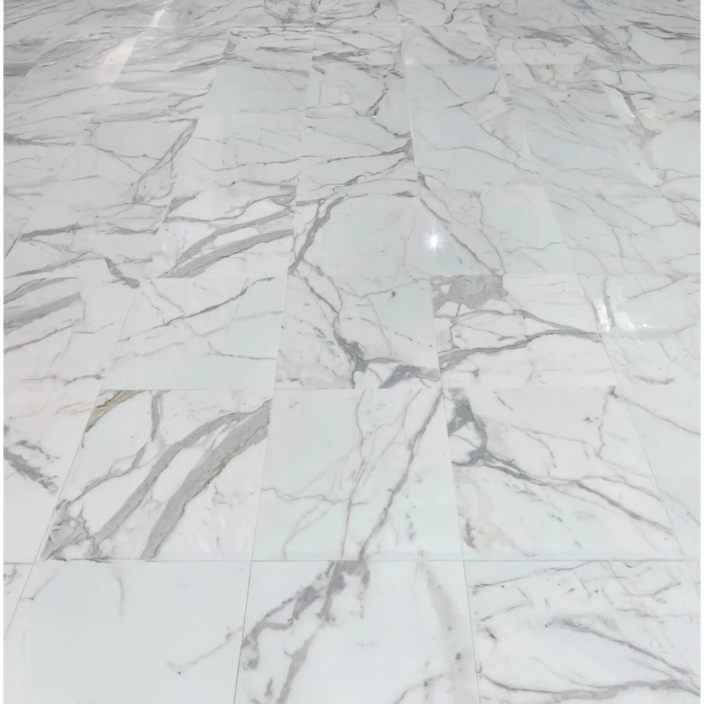 Calacatta Gold 5 Inch Hexagon Mosaic Marble Tile on a white marble tile floor