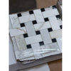 Calacatta Gold basketweave mosaic marble tile with black accents, polished