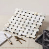 Calacatta gold basketweave mosaic marble tile with white and gold veined calacatta gold and dark gray grout