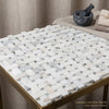 Calacatta gold basketweave mosaic marble tile polished or honed in white gray and blue-gray on gold framed table