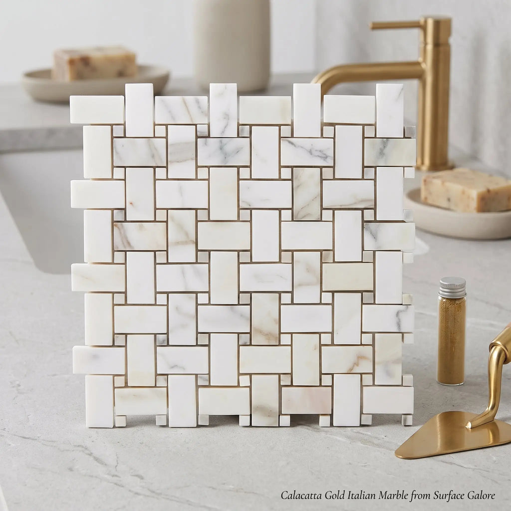 White calacatta gold basketweave mosaic marble tile with gold-toned grout on bathroom countertop polished or honed