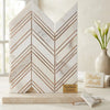 White marble bookends with rose gold metallic chevron stripes complement calacatta gold mosaic marble tile decor