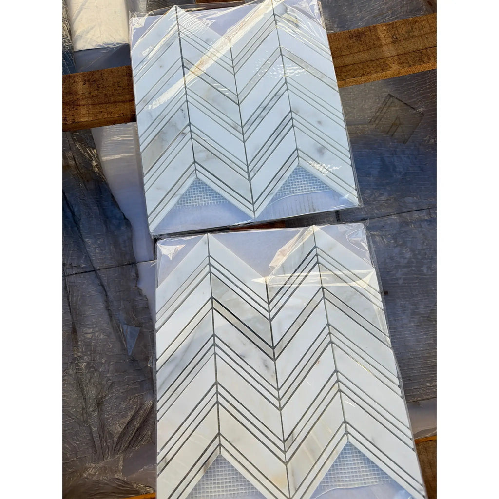 Calacatta Gold Chevron large polished mosaic marble tile with white chevron pattern and dark grout
