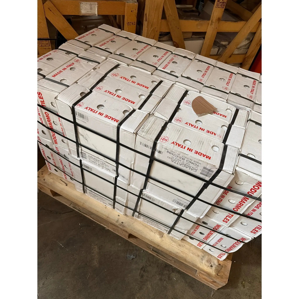 Calacatta Gold Marble 12x12 Polished or Honed stacked in white boxes with Made in Italy labels