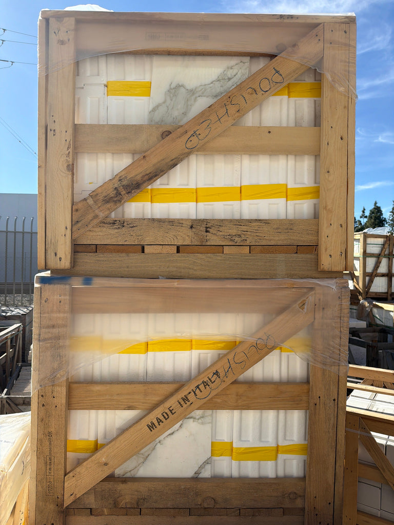 Calacatta Gold Marble 12x12 Polished tiles in stacked, plastic-wrapped crates
