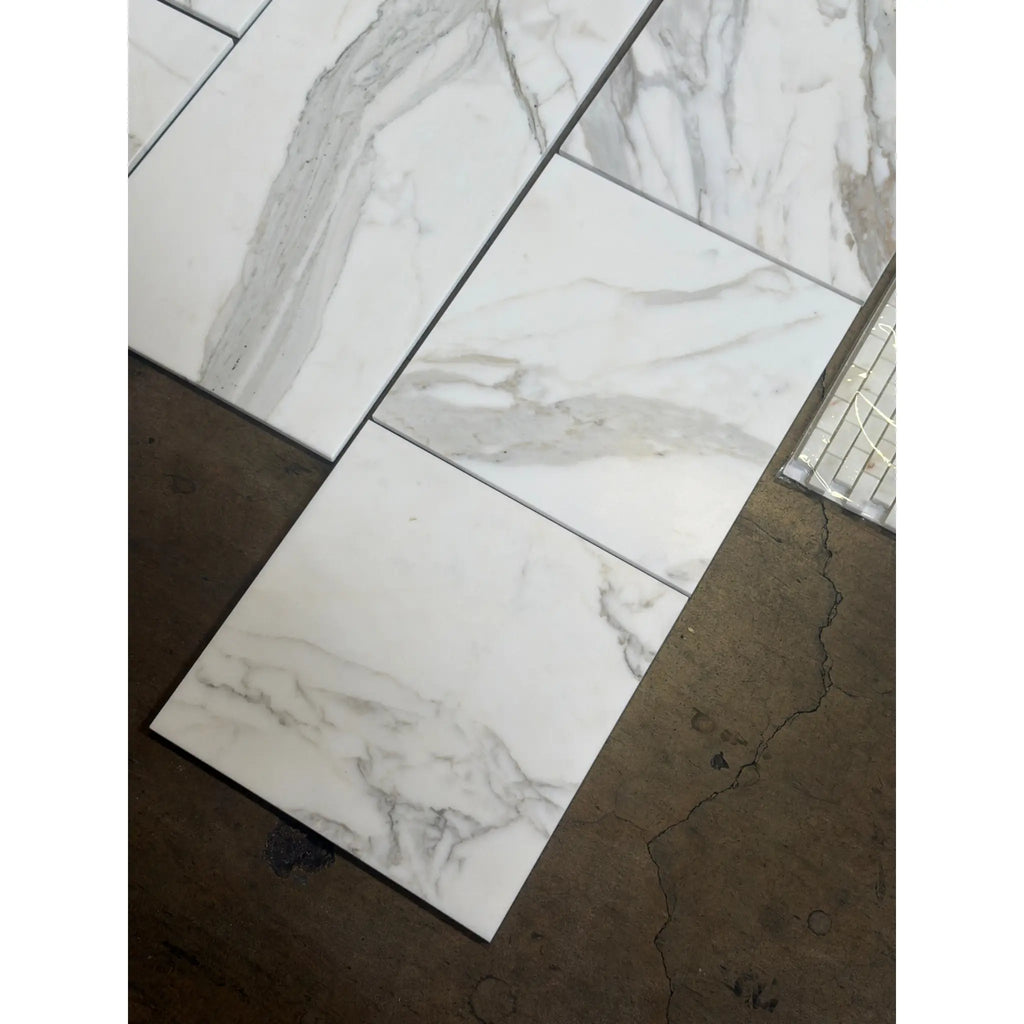 Calacatta Gold Marble 12x12 polished tiles with white marble-effect and gray veining in grid pattern