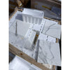 Calacatta Gold 12x12 marble tile with gray veins in foam packaging