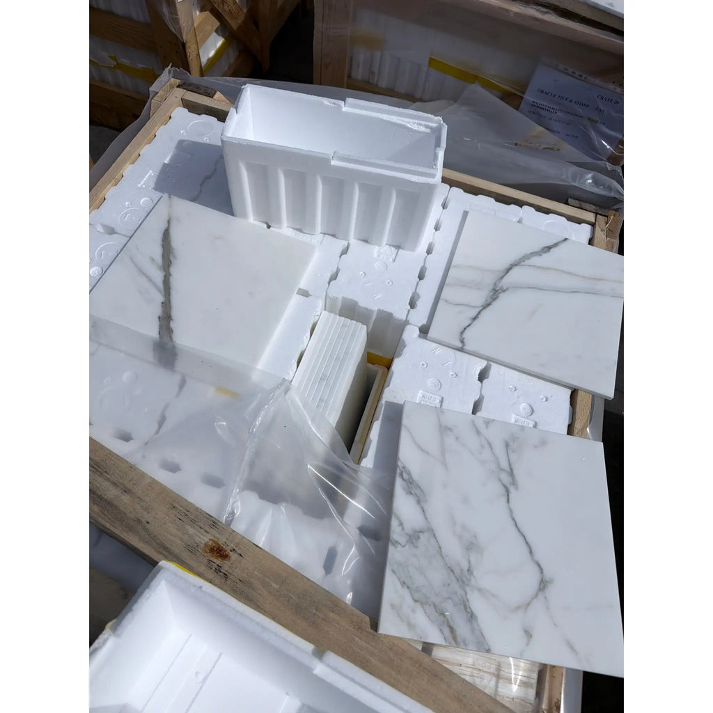 Calacatta Gold 12x12 marble tile with gray veins in foam packaging