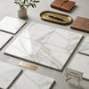 White marble tiles with gray and gold veining in a calacatta gold marble 12x12 polished or honed premium display