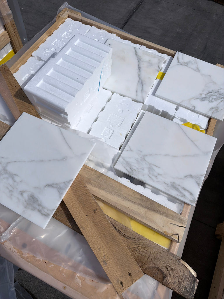 Calacatta Gold Marble 12x12 Polished white tiles with gray veining in crate