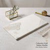 A sleek 12x24 calacatta gold marble serving board with polished white surface and subtle veining