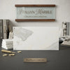 A sleek white calacatta gold marble slab with gold veining framed by wood from an italian marble collection
