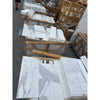 Stacked Calacatta Gold Marble 12x24 tiles with white background and grey veining