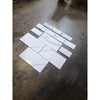 Calacatta Gold Marble 12x24 polished tiles in staggered white pattern