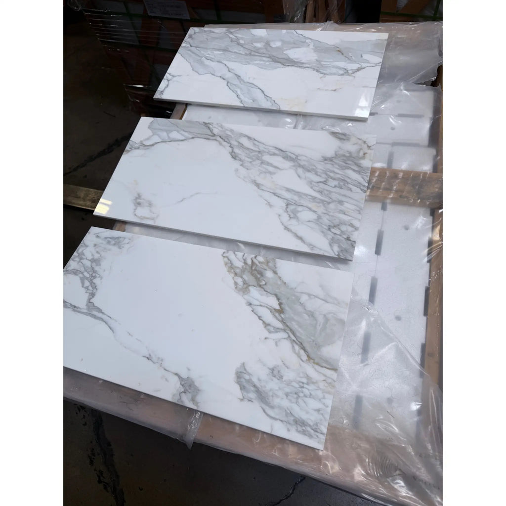 Calacatta Gold Marble 12x24 polished tiles in white marble-effect with gray veining, plastic wrapped