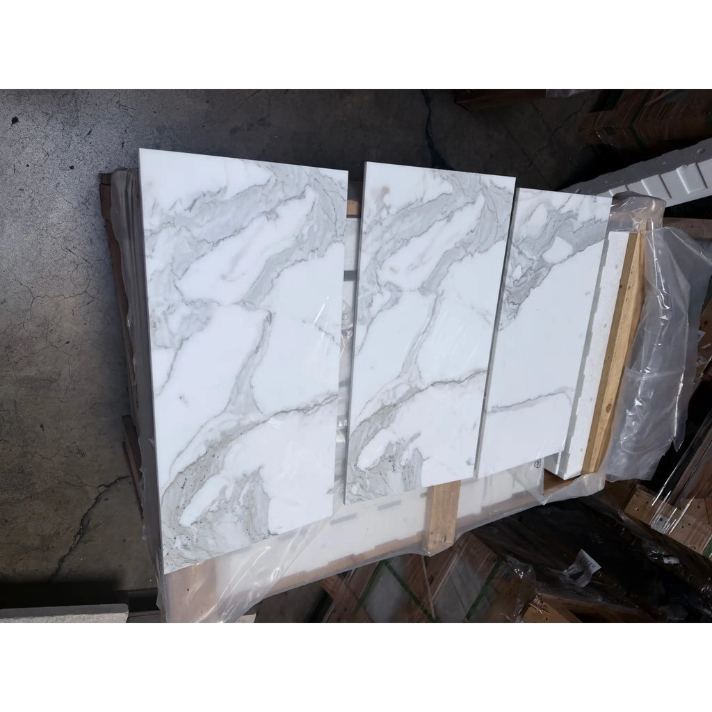 Calacatta Gold Marble 12x24 polished tiles with white marble-effect and gray veining on pallet