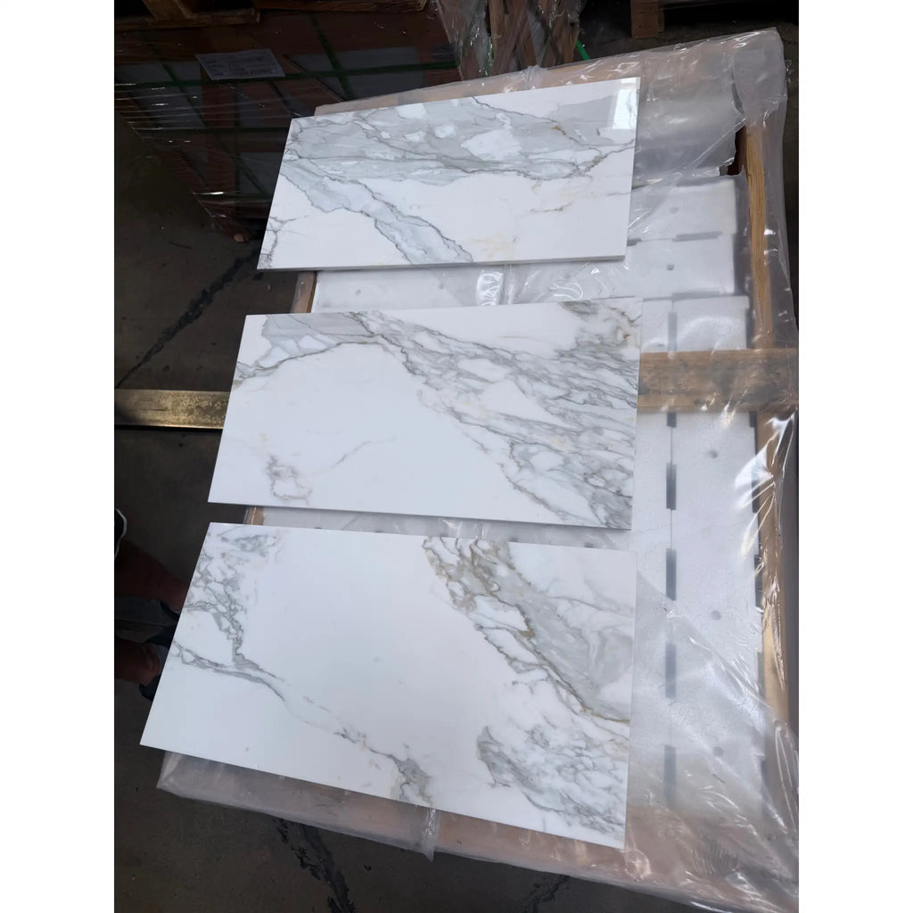 Calacatta Gold Marble 12x24 polished tiles with white marble-effect and gray veining in plastic wrap