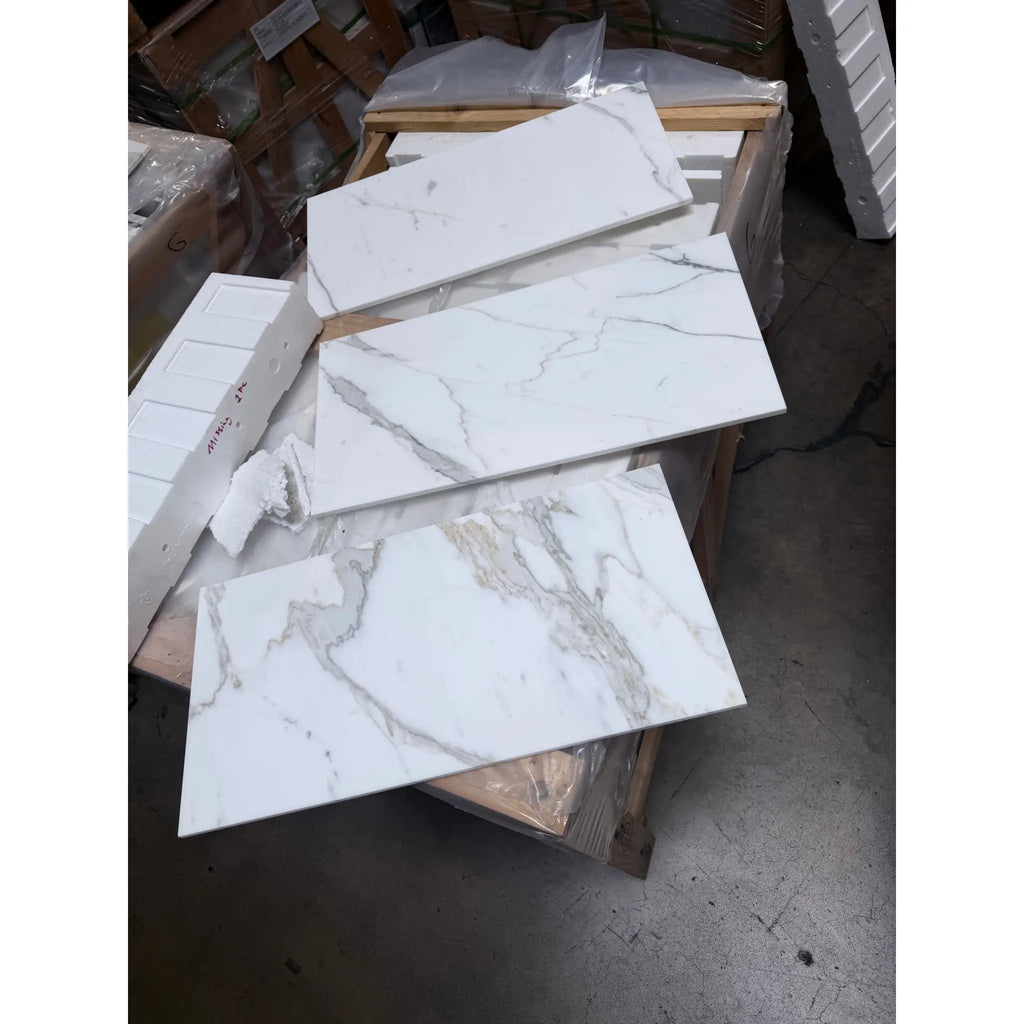Calacatta Gold Marble 12x24 polished tiles stacked on pallet