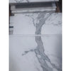 Calacatta Gold marble 12x24 polished slab with elegant gray veining on white marble surface