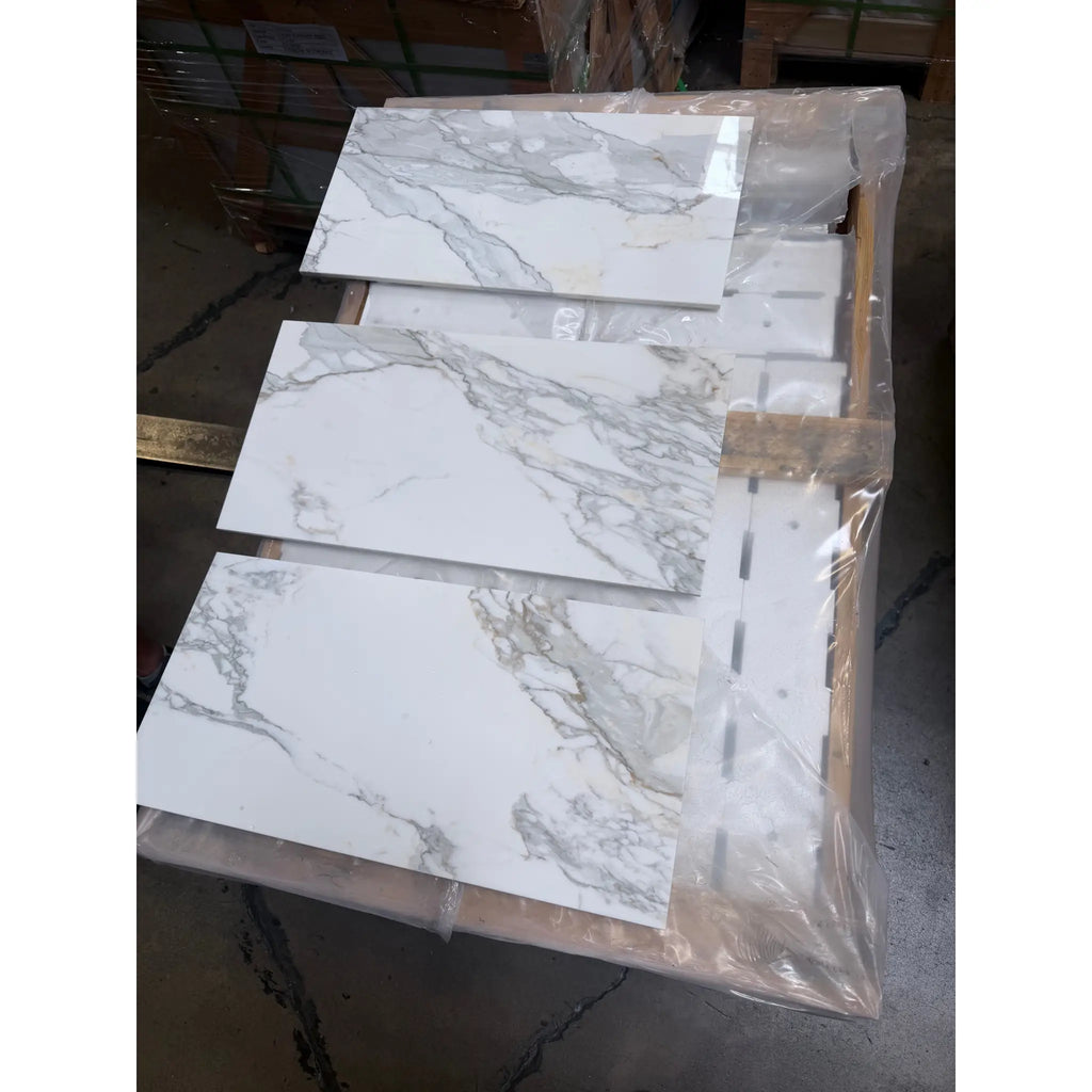 Calacatta Gold Marble 12x24 polished tiles with white marble and gray veining on pallet