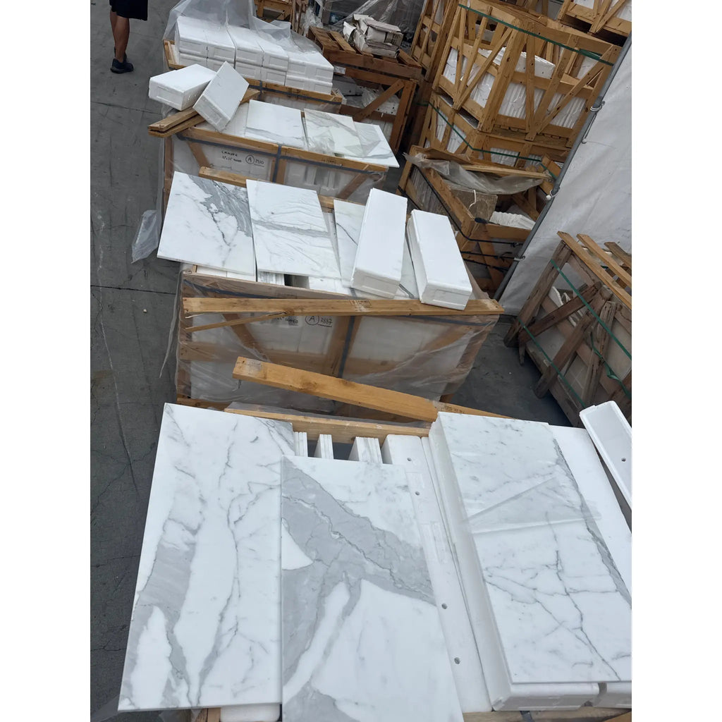 Stacked Calacatta Gold Marble 12x24 tiles with white background and grey veining