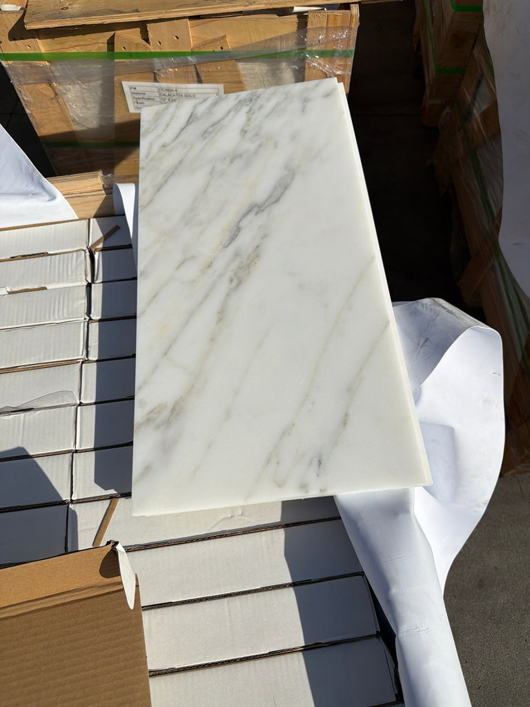 Calacatta Gold marble slab with white base and elegant gray veining, 12x24 polished or honed