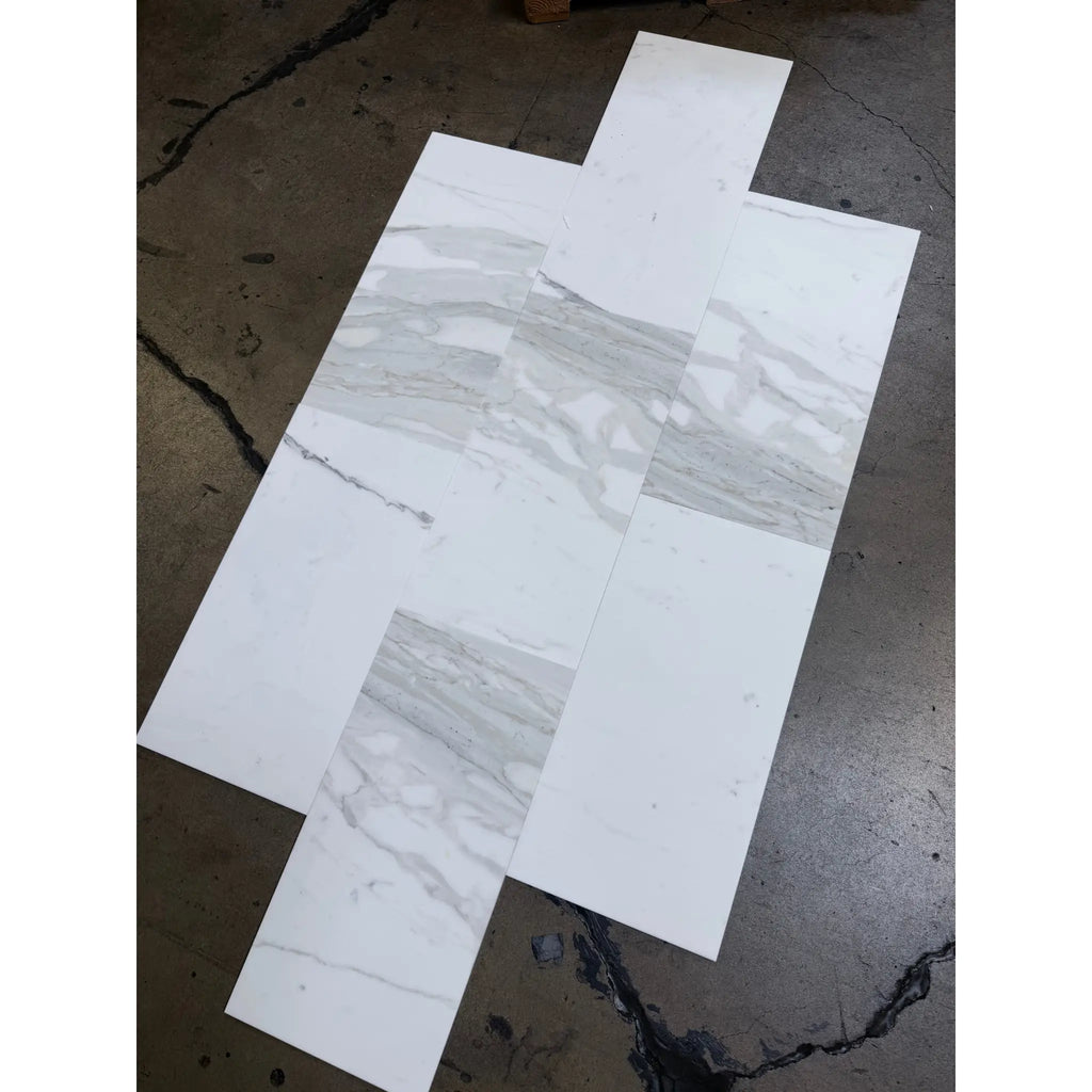 White and gray marble-look rectangular tiles from Calacatta Gold Marble collection