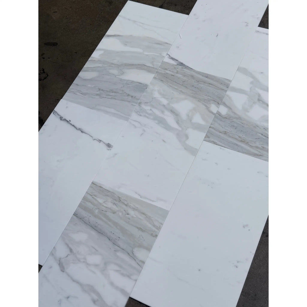 White and gray marble-look floor tiles from Calacatta Gold Marble 12X24 collection