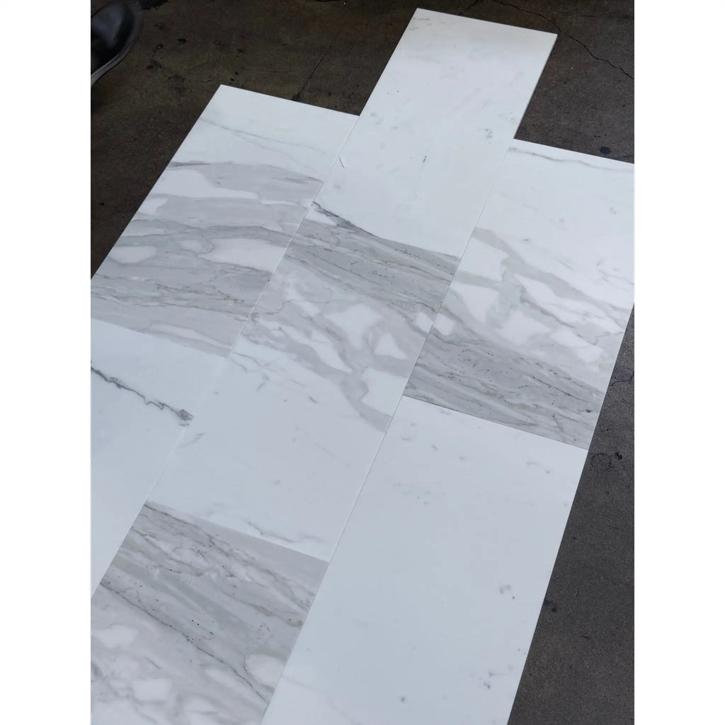 White and grey marble-patterned floor tiles arranged in a cross shape for Calacatta Gold Marble 12X24