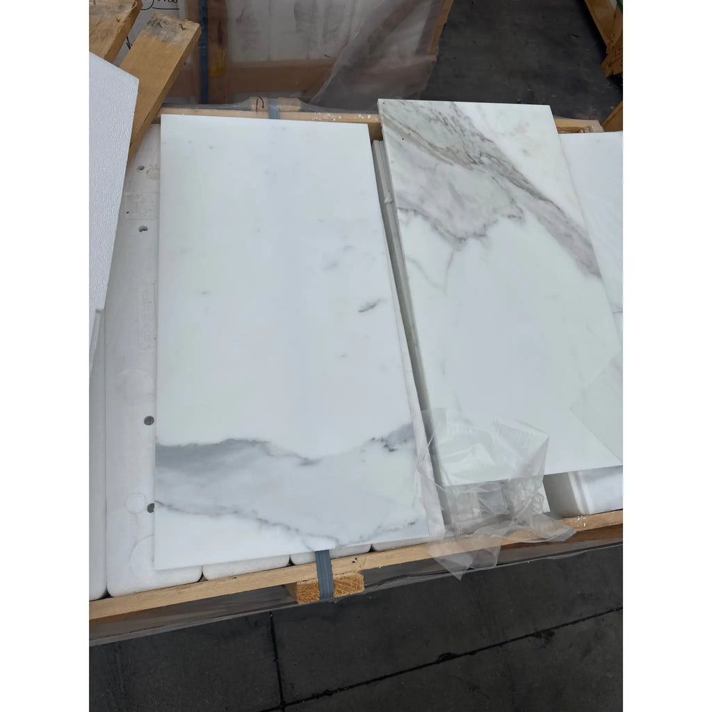 White marble-look tiles with grey veining from Calacatta Gold Marble 12X24 collection