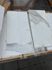 White marble-look tiles with grey veining from Calacatta Gold Marble 12X24 collection