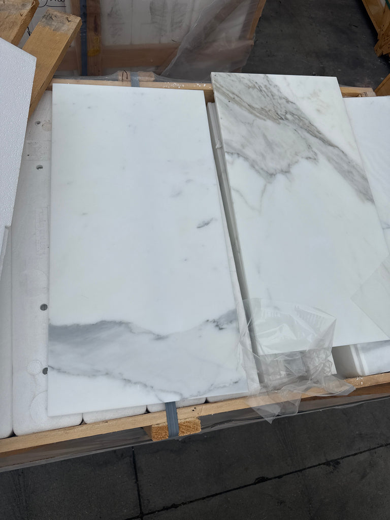 White marble-look tiles with grey veining from Calacatta Gold Marble 12X24 collection