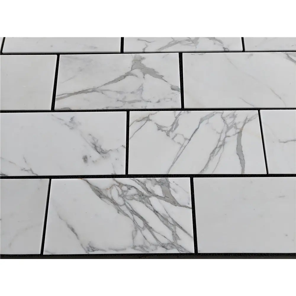 White marble-patterned rectangular tiles from Calacatta Gold Marble 12X24 collection