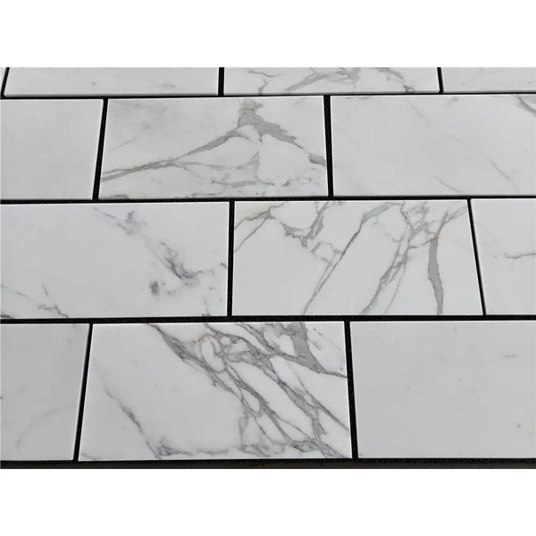 White marble-patterned rectangular tiles from Calacatta Gold Marble 12X24 collection