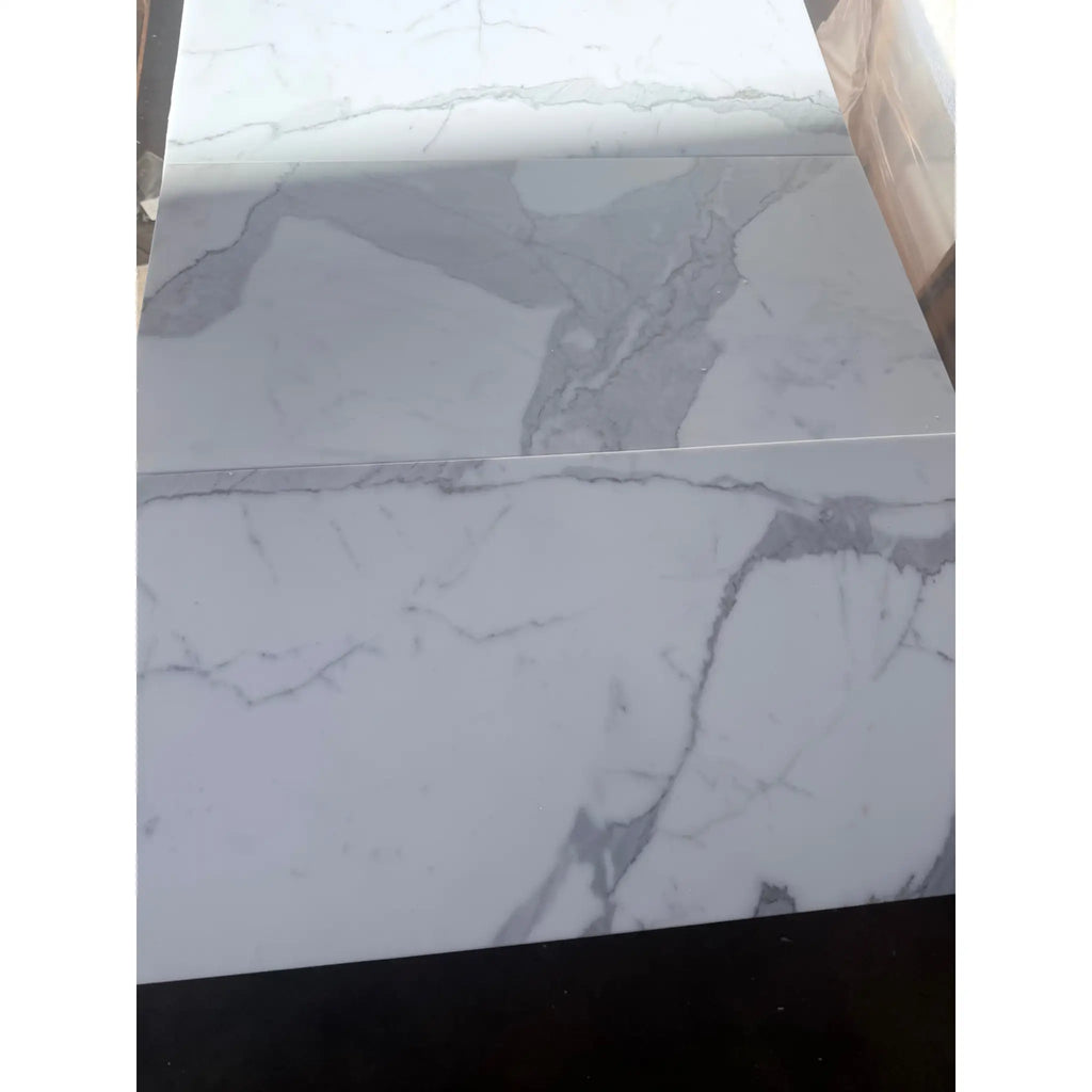 White marble tiles with grey veining from Calacatta Gold Marble 12X24 collection