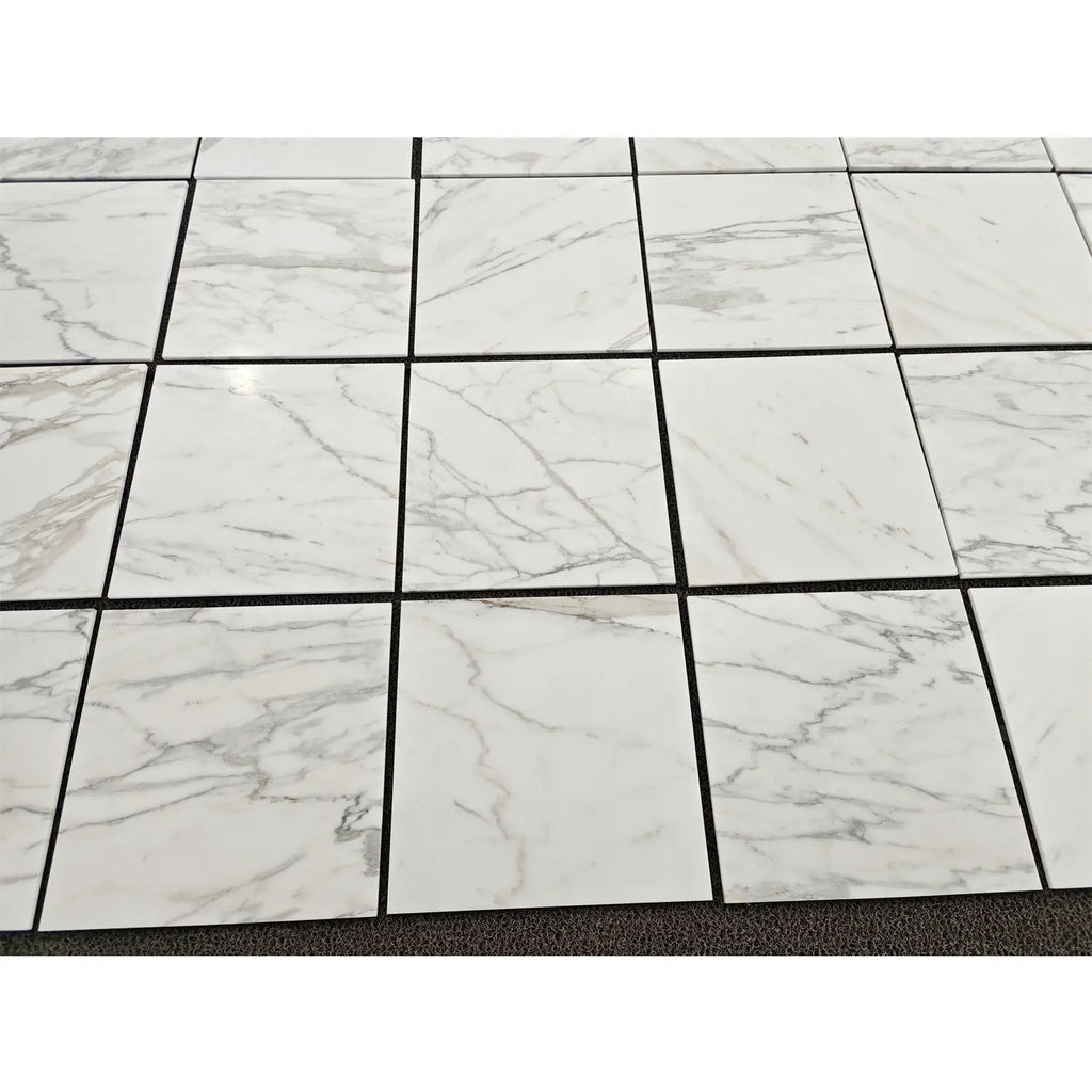 Calacatta gold marble 18x18 polished or honed white marble-effect square tiles with subtle gray veining in a grid pattern