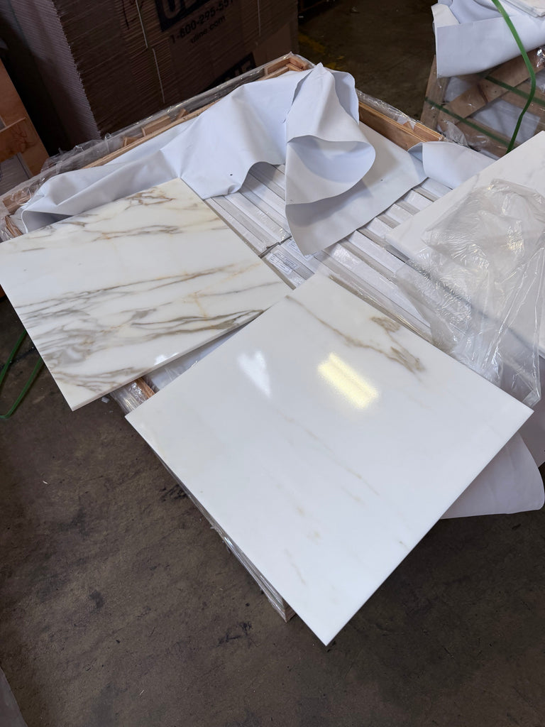 Calacatta Gold Marble 18x18 polished tiles with golden veining, stacked