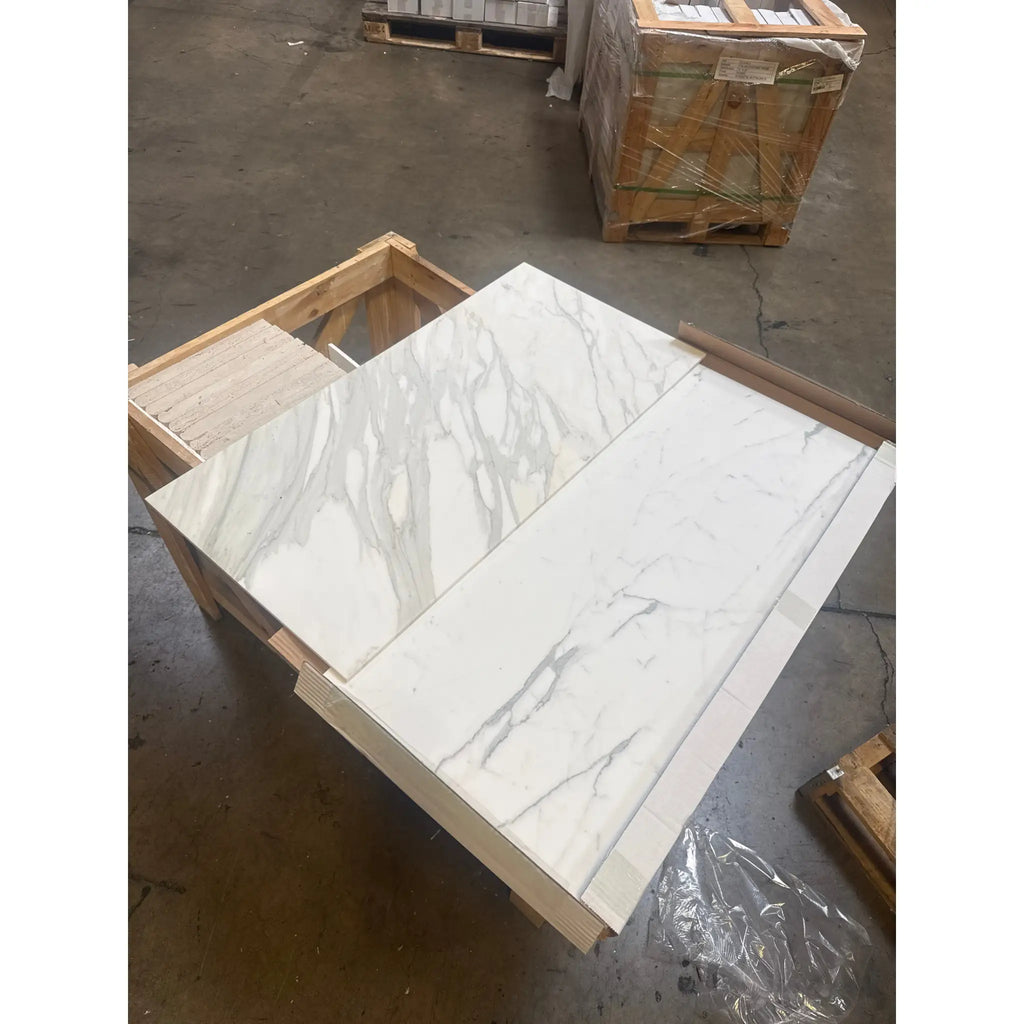 Two rectangular Calacatta Gold Marble tiles with gray veining in polished or honed finish