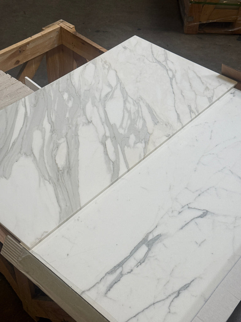 Calacatta Gold Marble 18X36 polished or honed with two white slabs featuring gray veining
