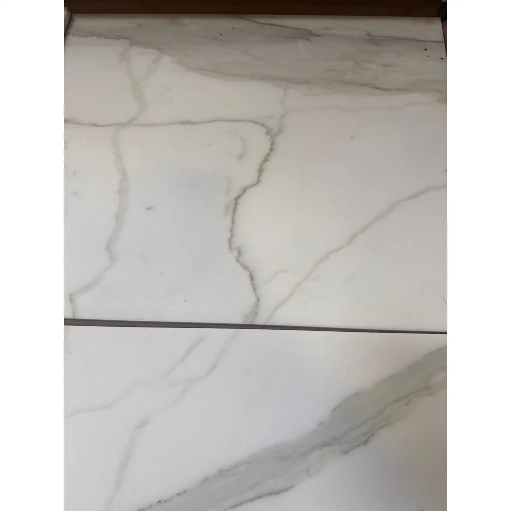 White marble-look porcelain tiles with grey veining from Calacatta Gold Marble collection