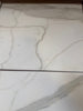 White marble-look porcelain tiles with grey veining from Calacatta Gold Marble collection