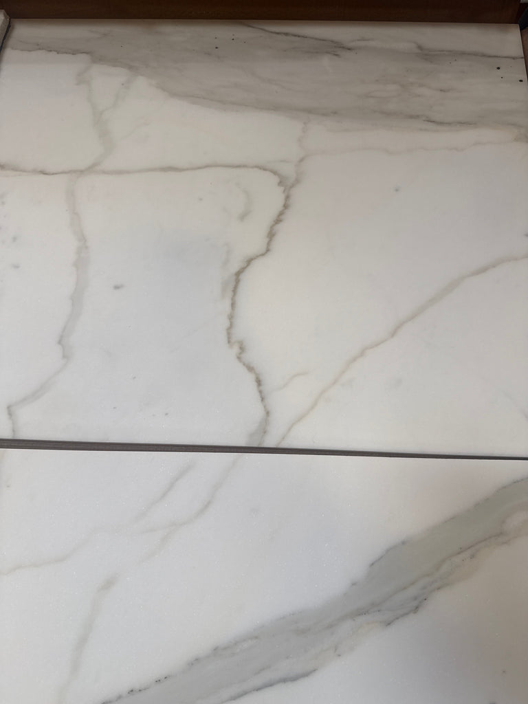 White marble-look porcelain tiles with grey veining from Calacatta Gold Marble collection