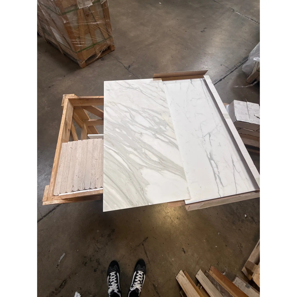 White marble-look porcelain tiles with grey veining from Calacatta Gold Marble collection