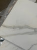 White marble tile with gray veining from Calacatta Gold Marble 18x36 collection