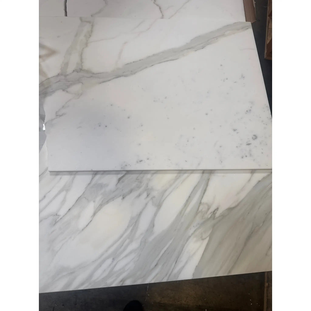 White marble tiles with grey veining from Calacatta Gold Marble 18X36 collection