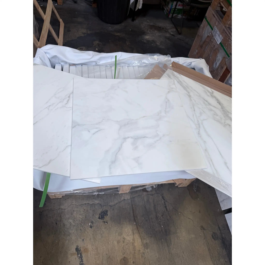 White marble-patterned tiles from Calacatta Gold Marble 24x24 polished or honed collection