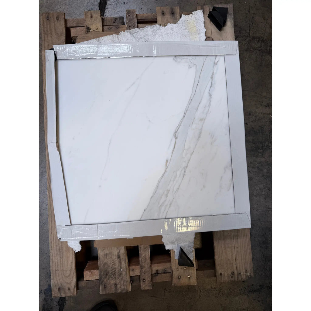 Calacatta Gold 24x24 polished white marble tile with gray veining on wooden pallet