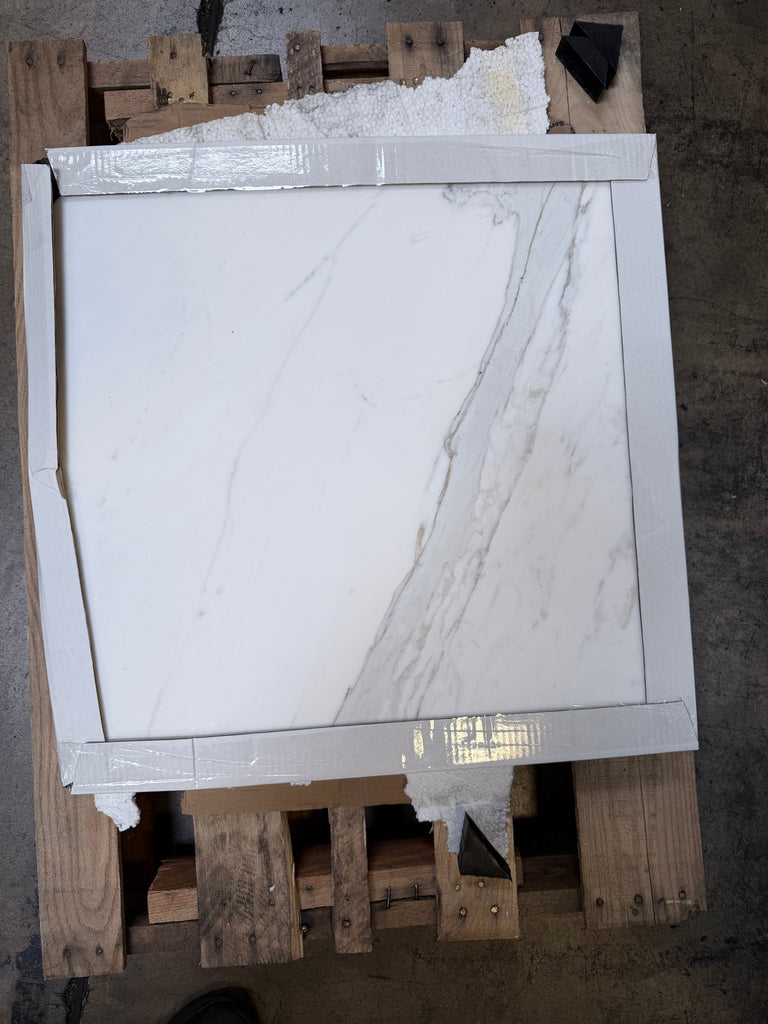 Calacatta Gold 24x24 polished white marble tile with gray veining on wooden pallet