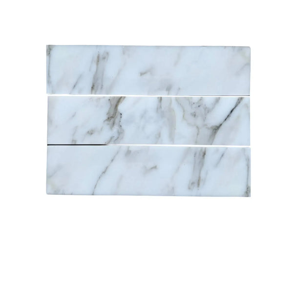 Three Calacatta Gold Marble 3’’ X 12’’ Field Tiles with elegant marble patterns