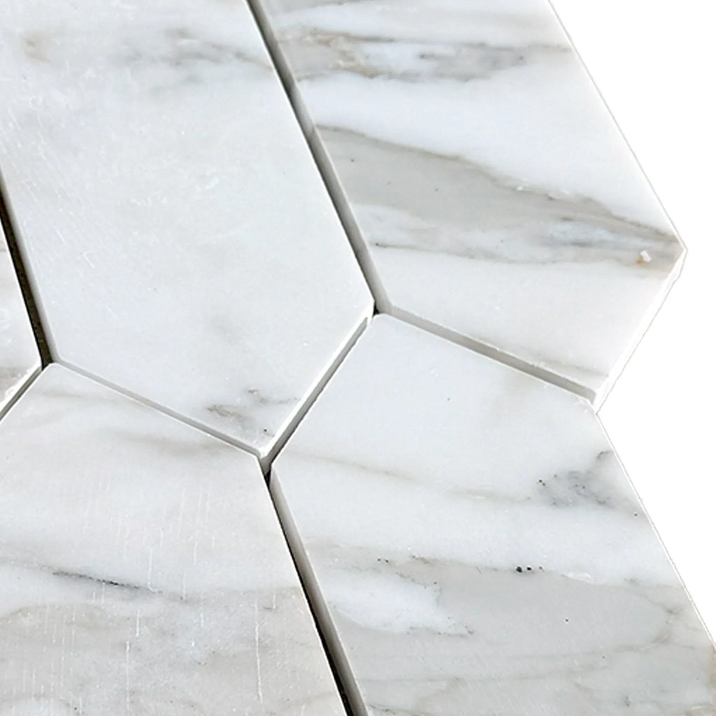 White marble elongated hexagon tiles in Calacatta Gold Marble picket mosaic design